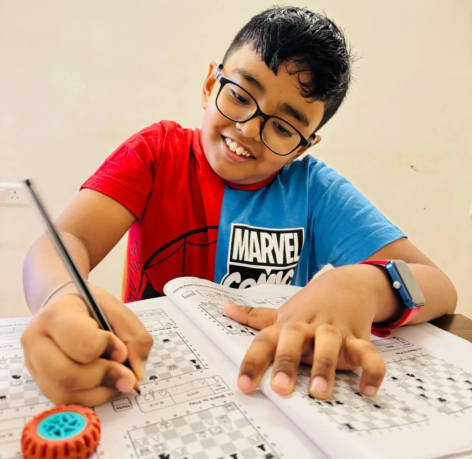 Young boy drawing and learning chess basics at GKS Academy