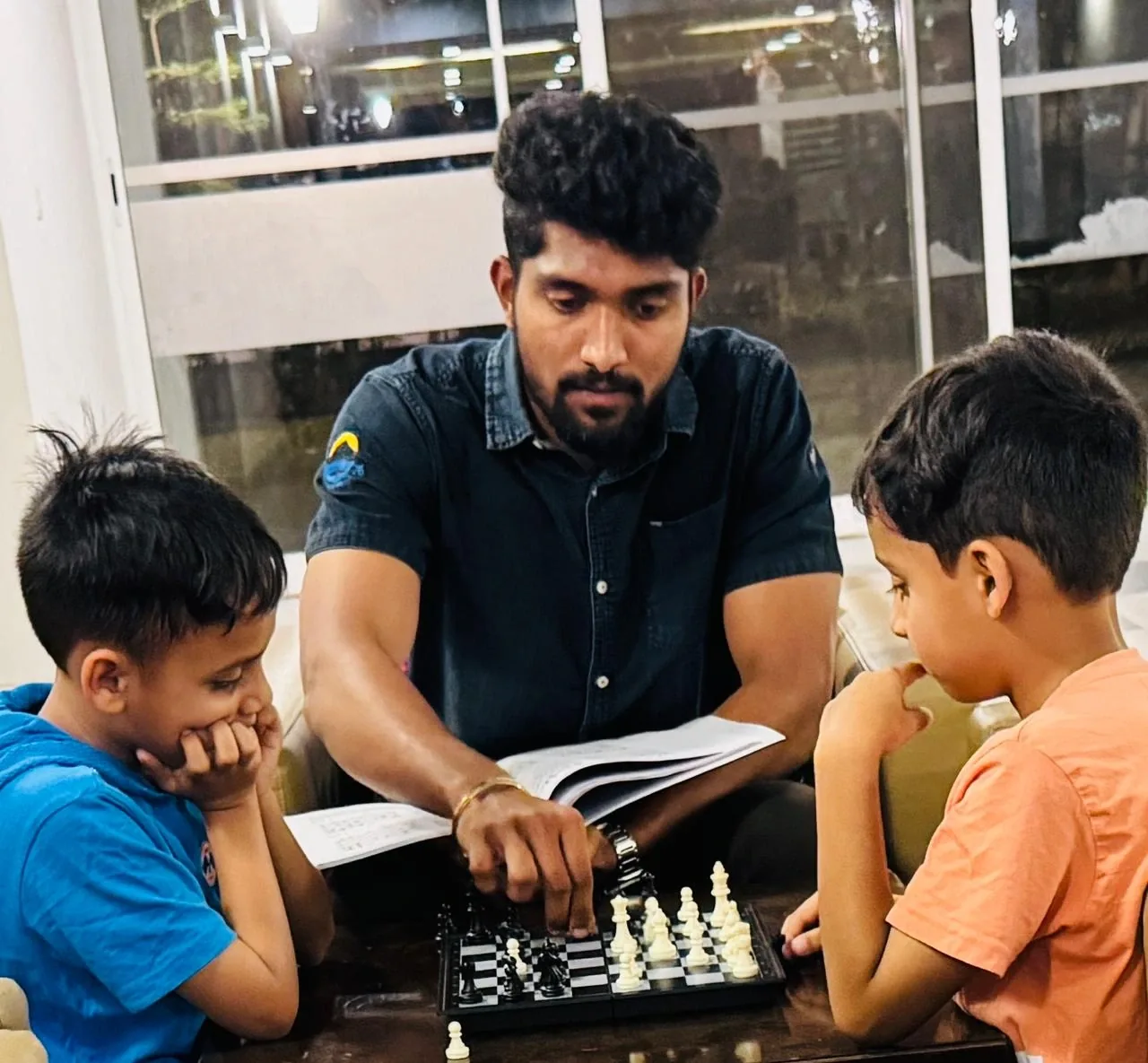 Coach teaching chess basics to young kids
