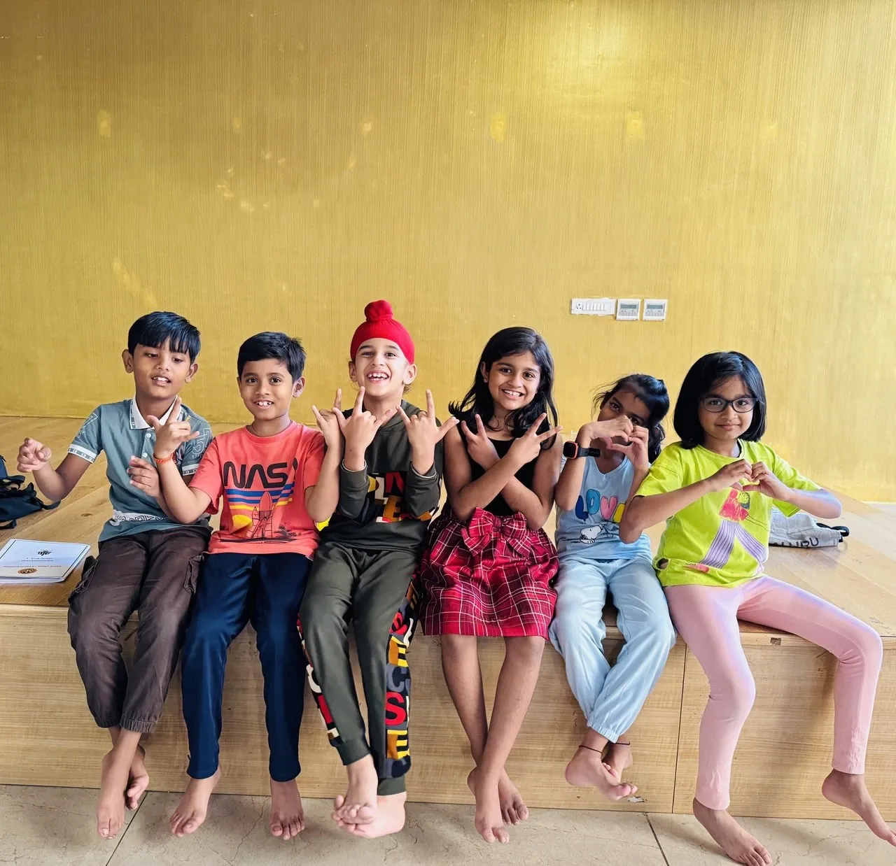 Students enjoying fun time after chess session with a group dance pose