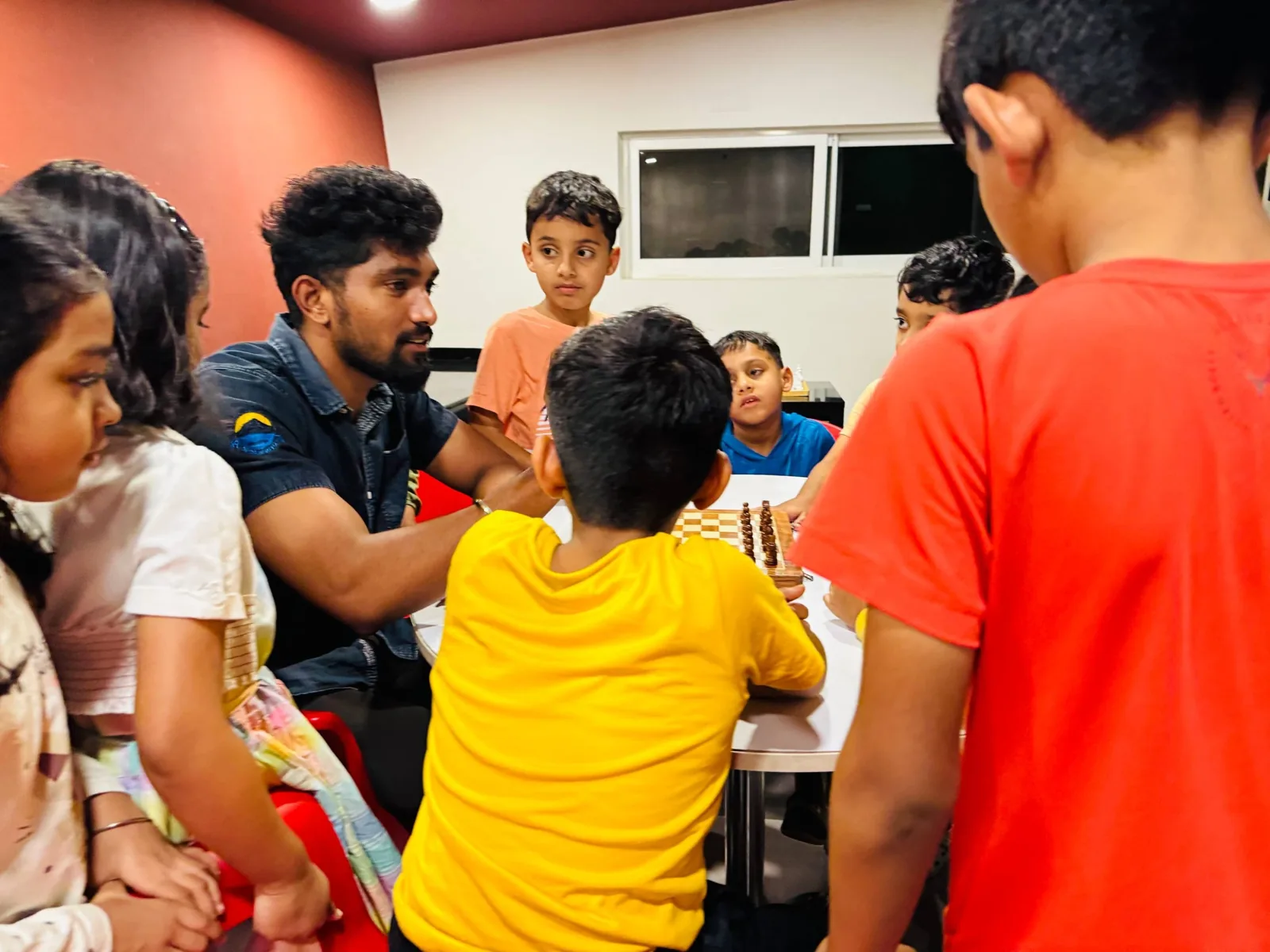 Group of kids watching a chess instructor at GKS Academy