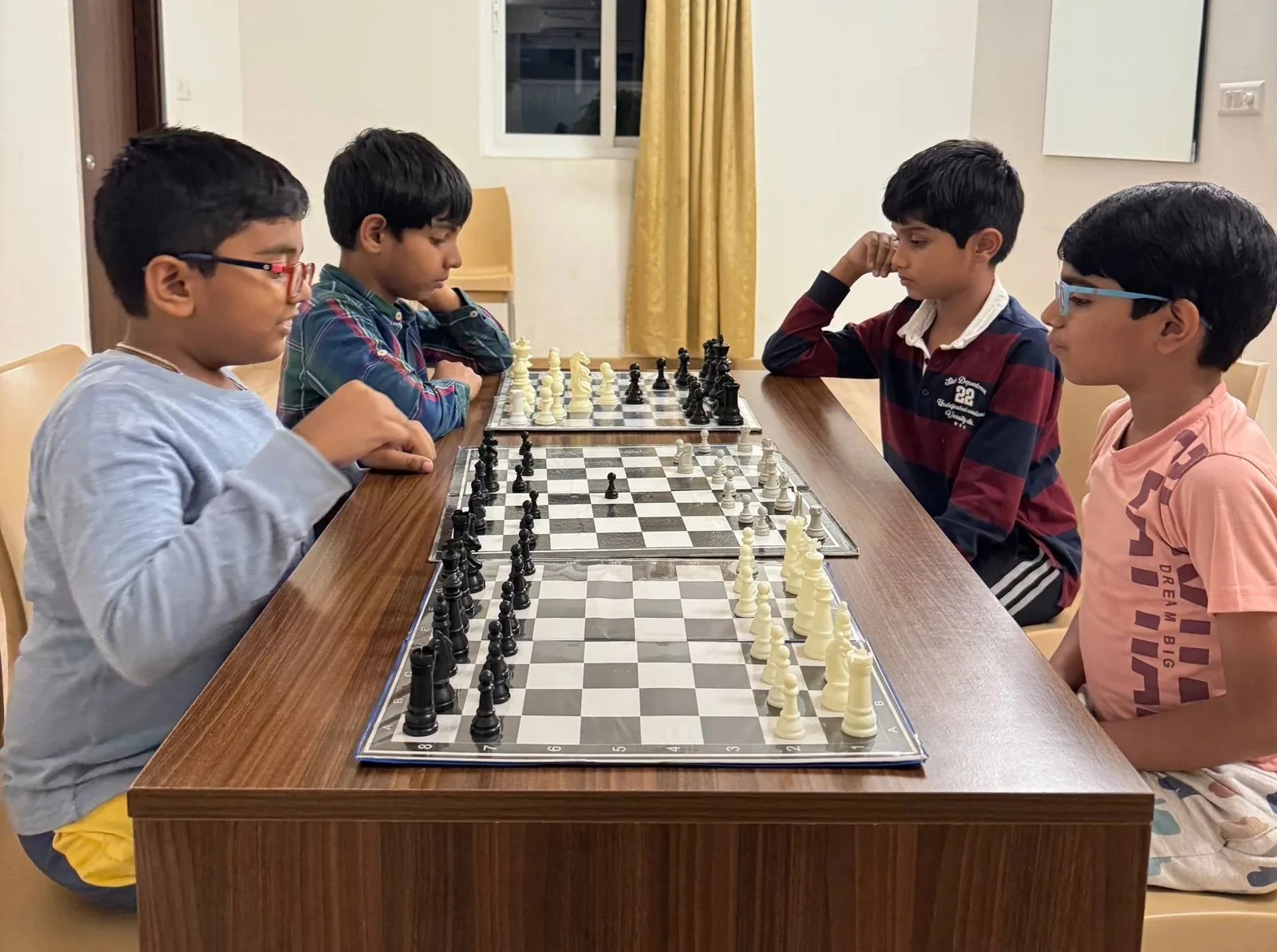 Children participating in a chess tournament setup in GKS Academy